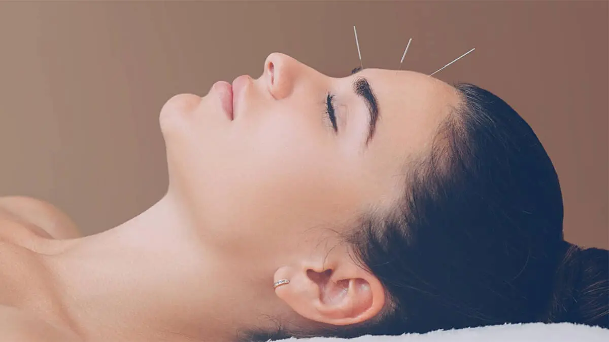 A woman is getting her face waxed