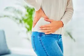 A woman holding her stomach in the air.