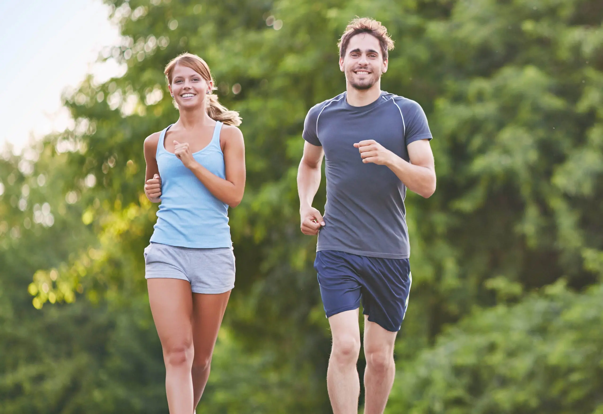 A man and woman running in the park