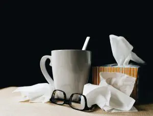 A cup of coffee and some tissues on the table