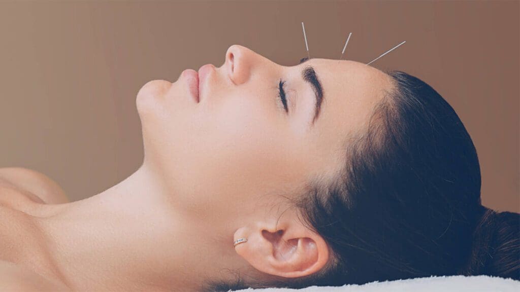 A woman is getting her face waxed