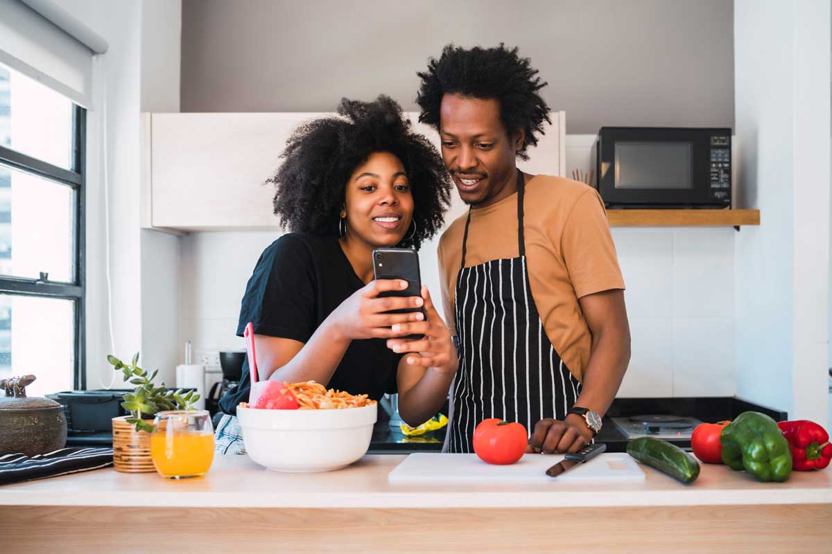 A man and woman are looking at a phone.