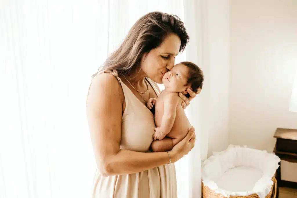 A woman holding her baby in her arms.