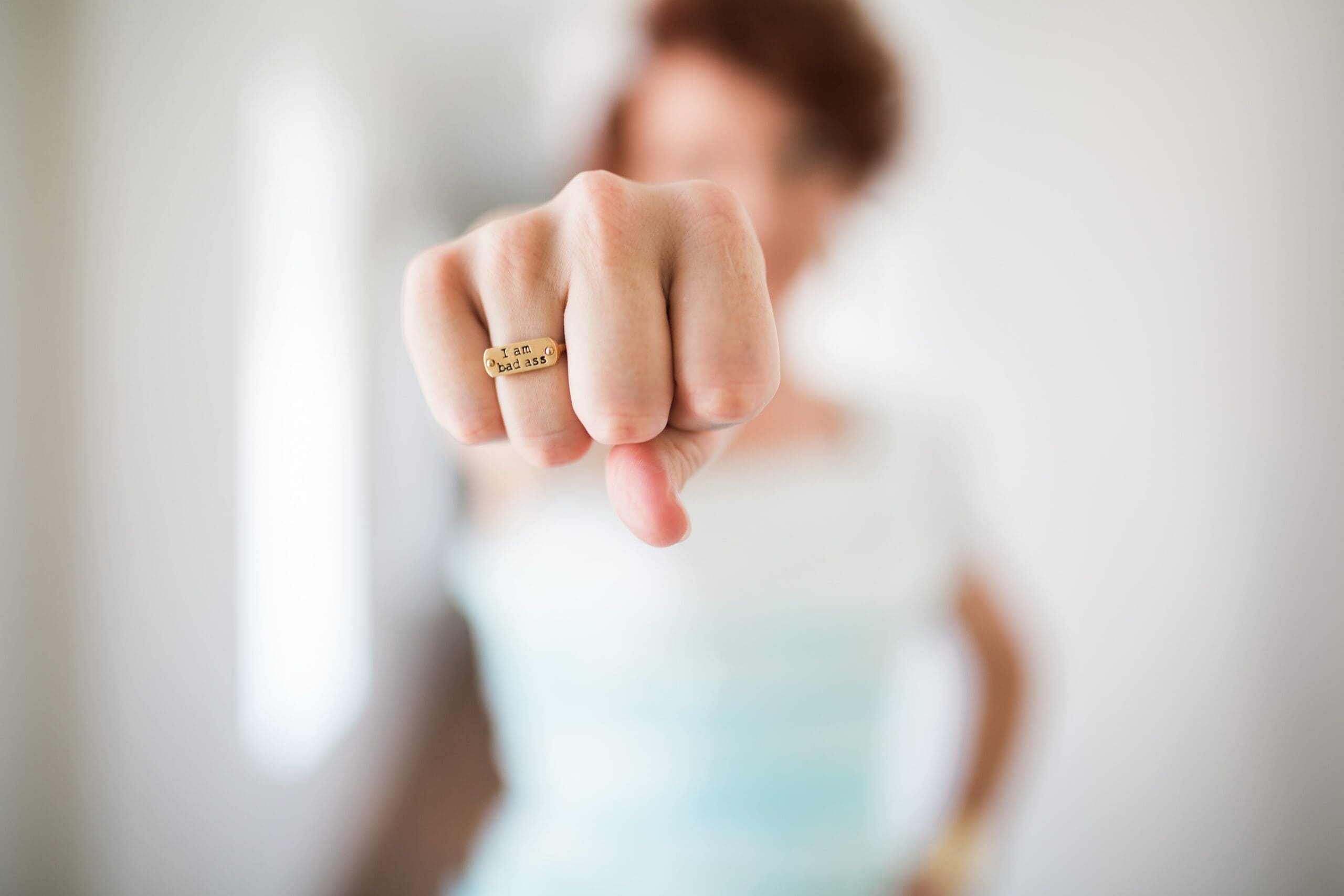 A woman is holding her finger up to the camera.