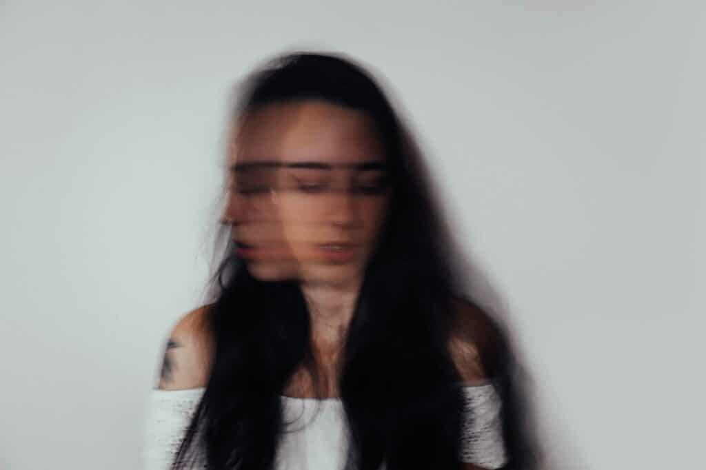 A blurry picture of a woman with long hair.