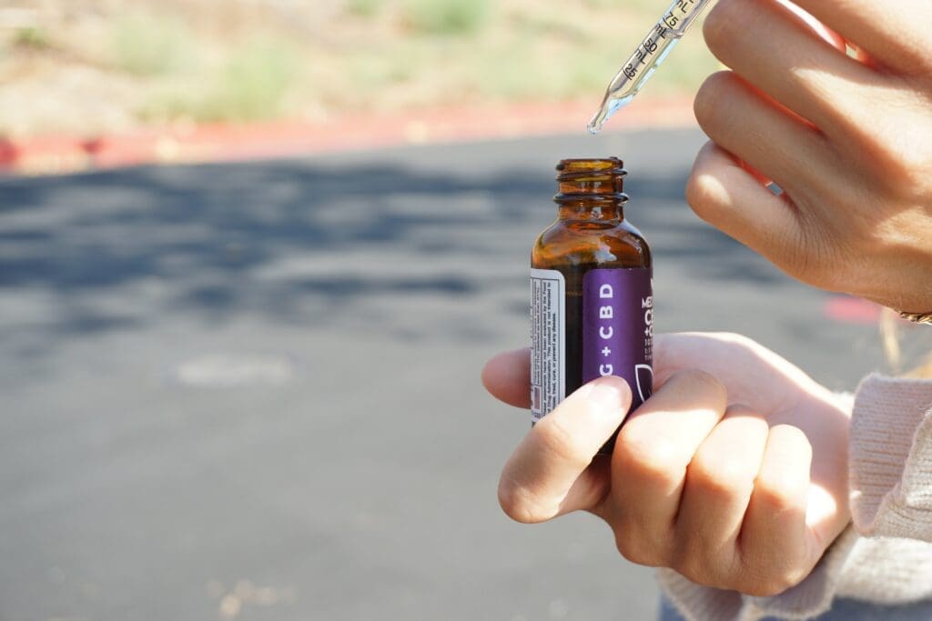 A person holding an empty bottle of medicine.