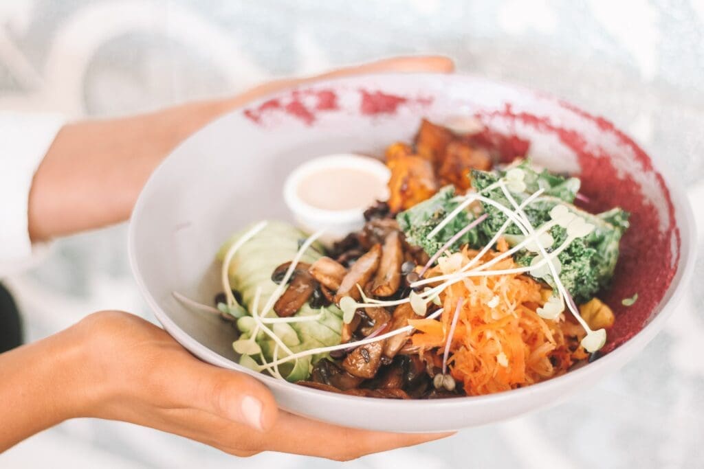 A person holding onto a bowl of food