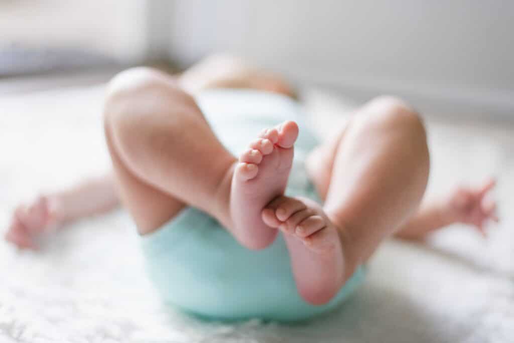 A baby 's feet are shown in the air.