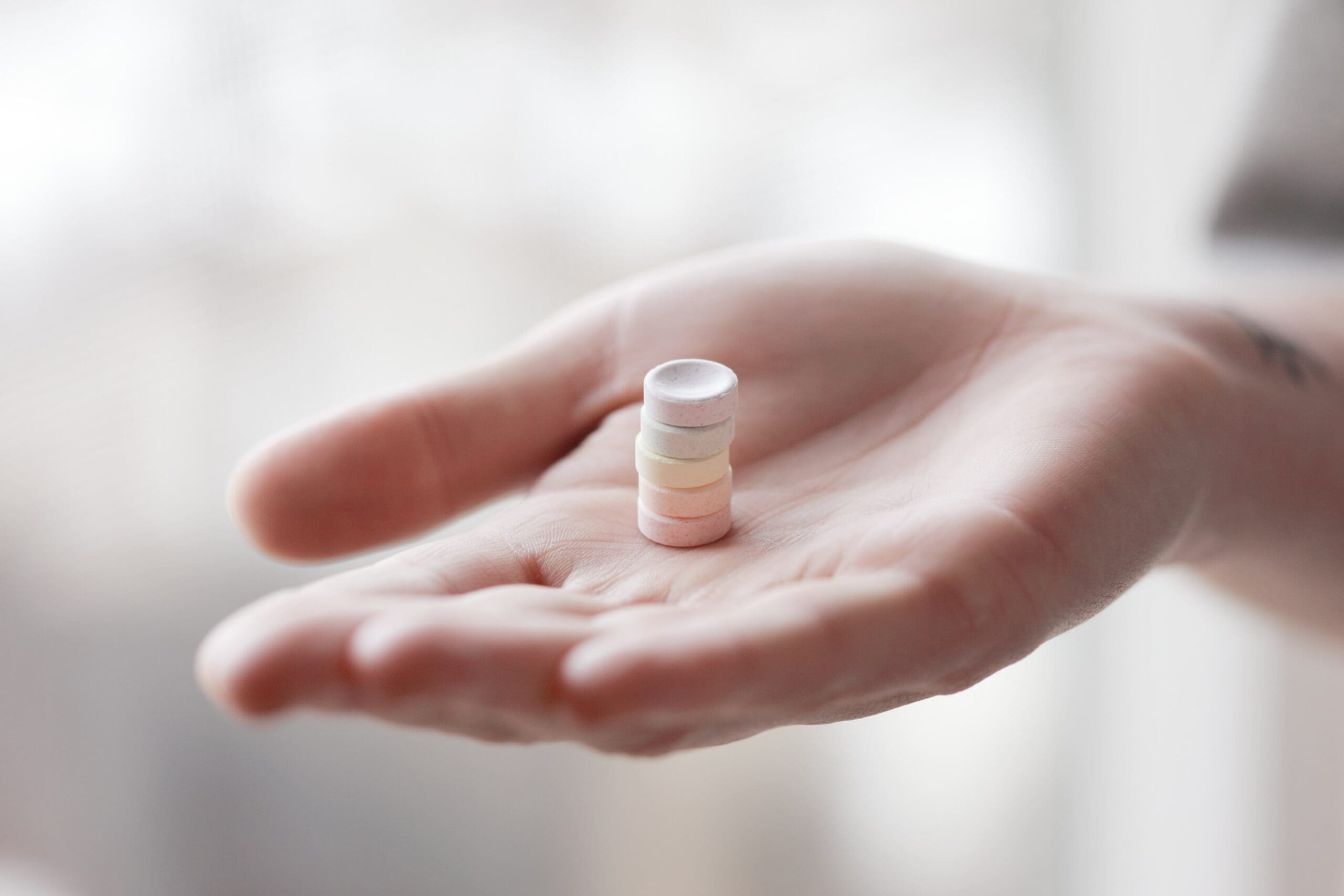 A person holding a pill bottle in their hand.