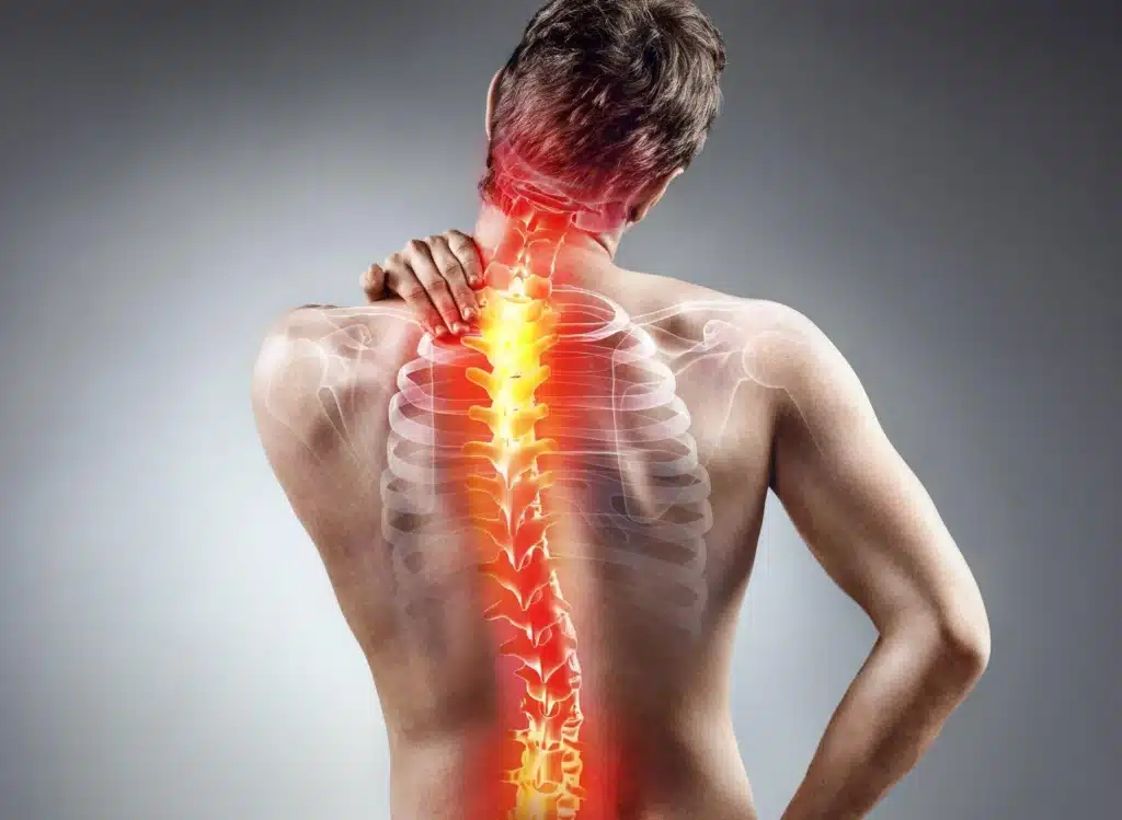 A man with his back turned and the spine highlighted in red.