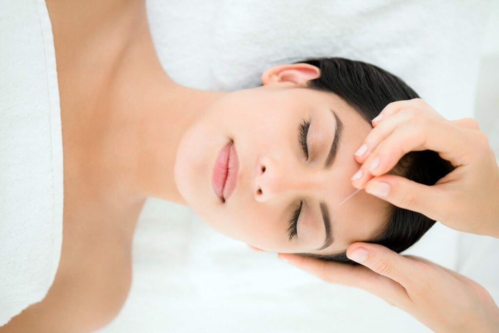 A woman laying down with her eyes closed.