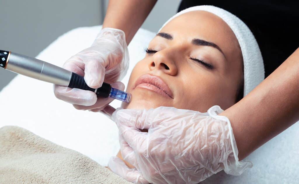 A woman getting her face waxed at the spa