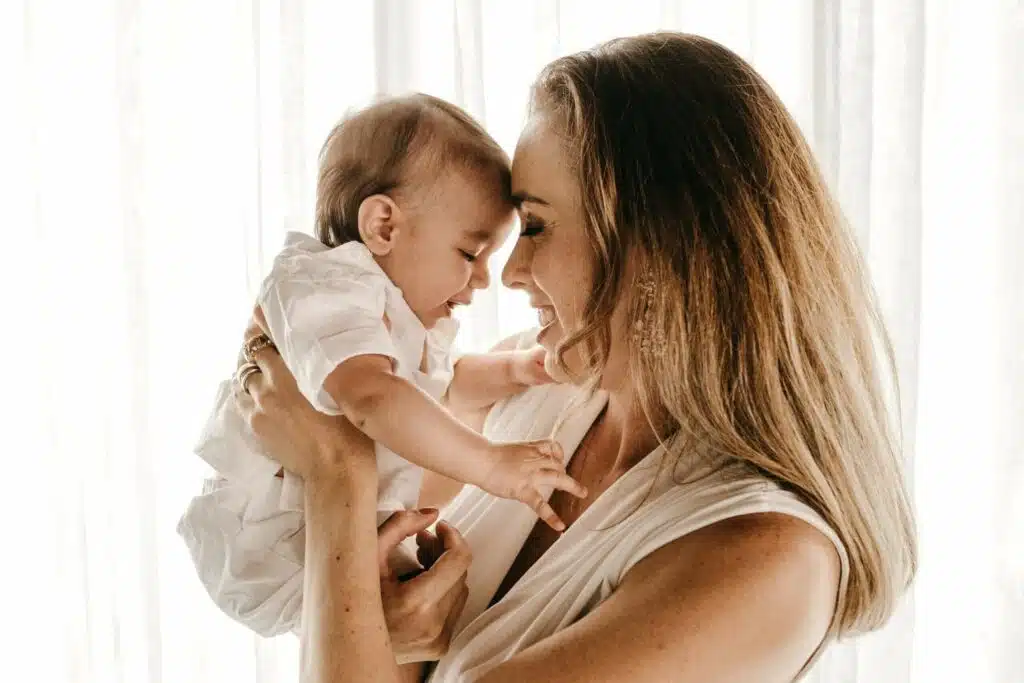 Mother and baby pressing foreheads together