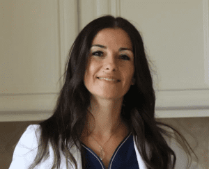 A woman with long hair wearing white and blue.