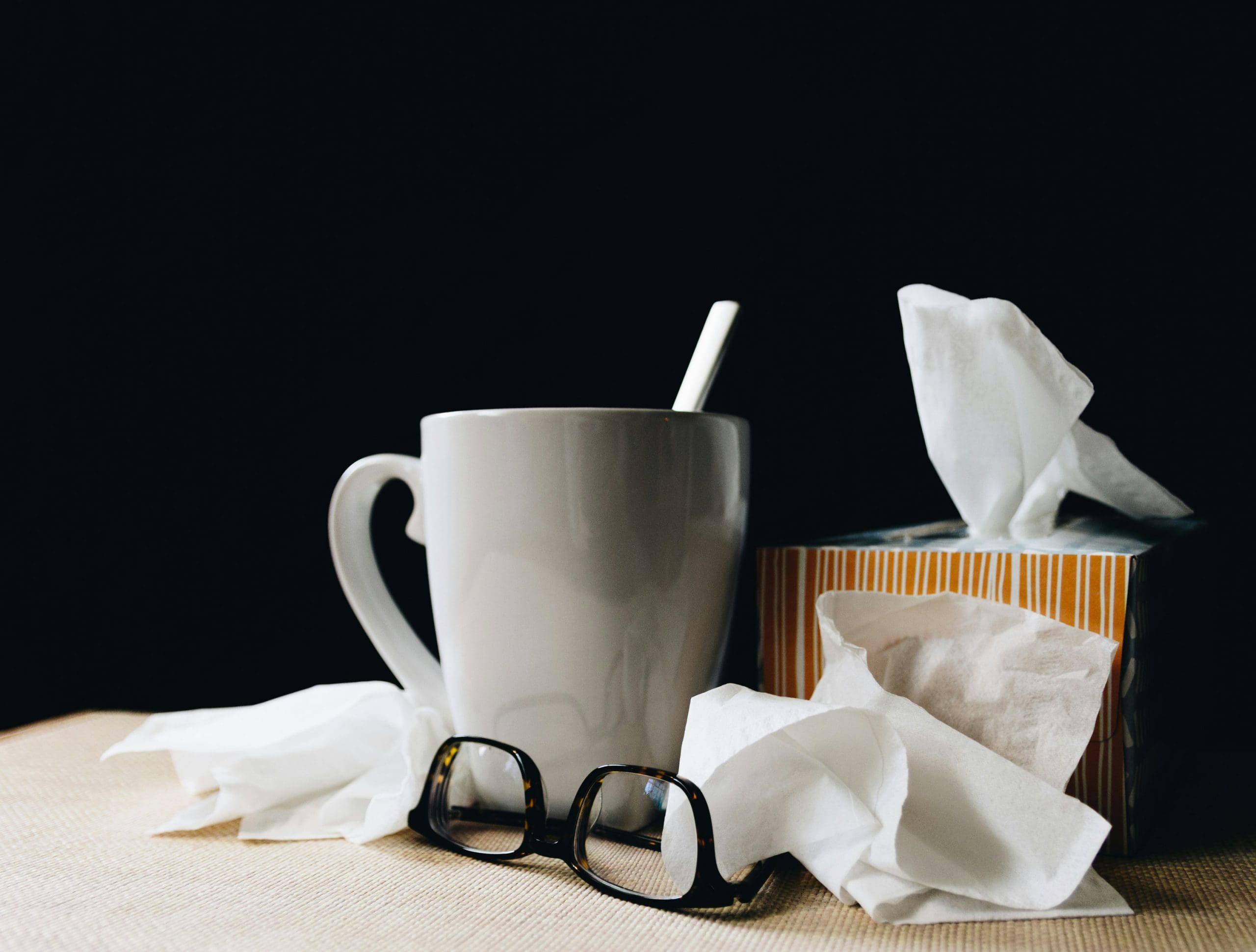 A cup of coffee and some tissues on the table