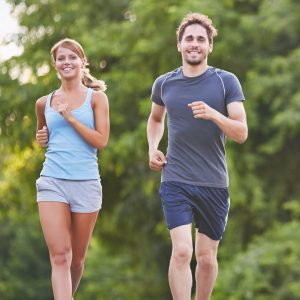 A man and woman running in the park