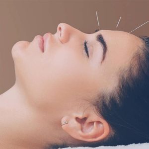 A woman is getting her face waxed