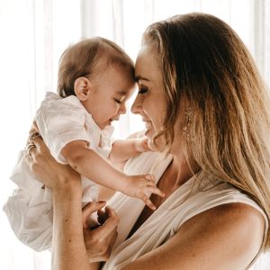 A woman holding a baby in her arms.